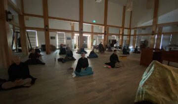 Meditation group sitting in a spacious hall