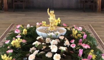 Decorative altar with flowers and statue
